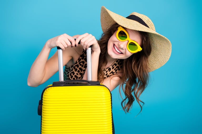 Young woman wearing trendy outfit with yellow sunglasses and hat, summer travel excitement