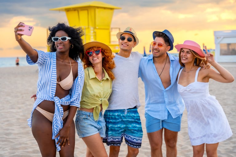 Group of cheerful friends enjoying sunny beach day