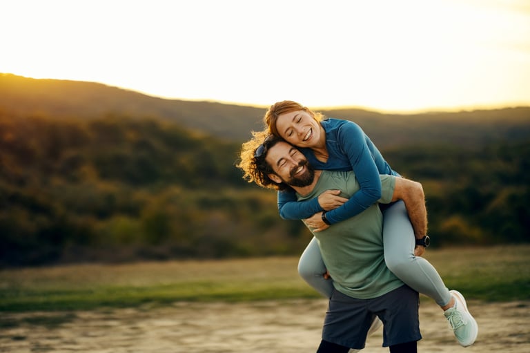 Happy couple enjoying beautiful sunset outdoors