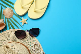 Flat lay with beach accessories on color background